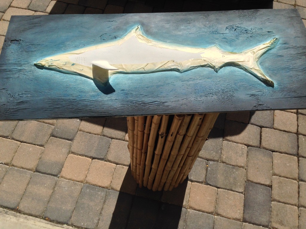 The entire shark sculpture was primed with a spray can of Kilz and the ocean blue water background painted