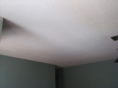 Living room water damaged drywall ceiling repaired and textured. Ready for primer and paint.